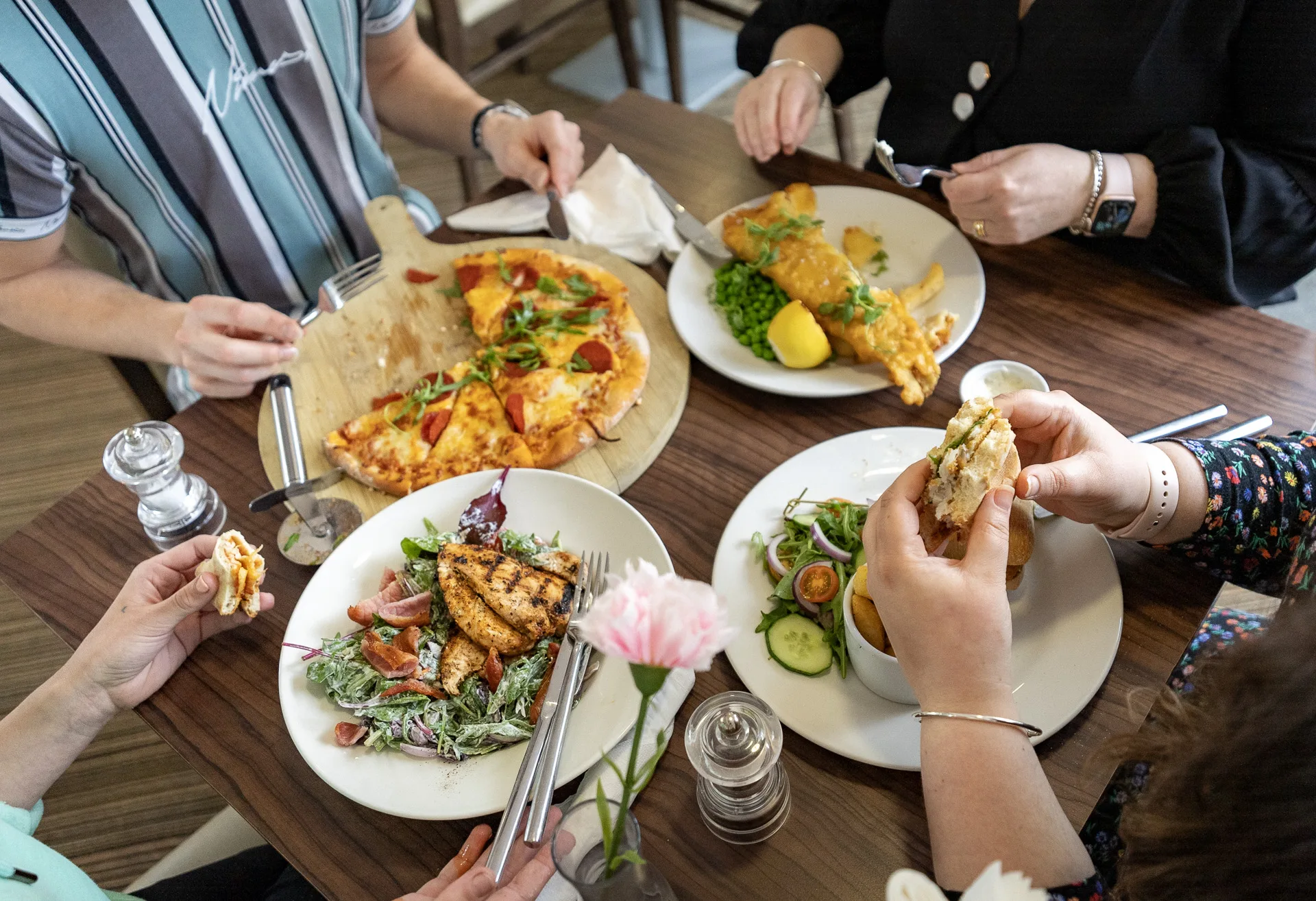 group of people eating at restaurant in milton keynes
