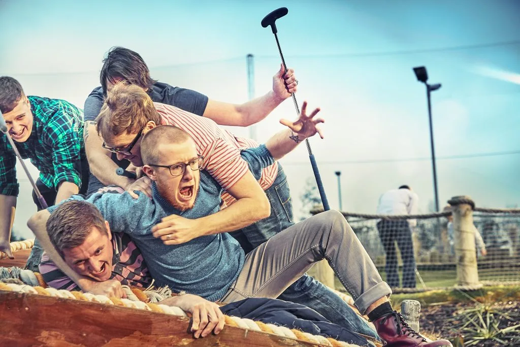group of adults laughing and joking playing crazy golf in milton keynes