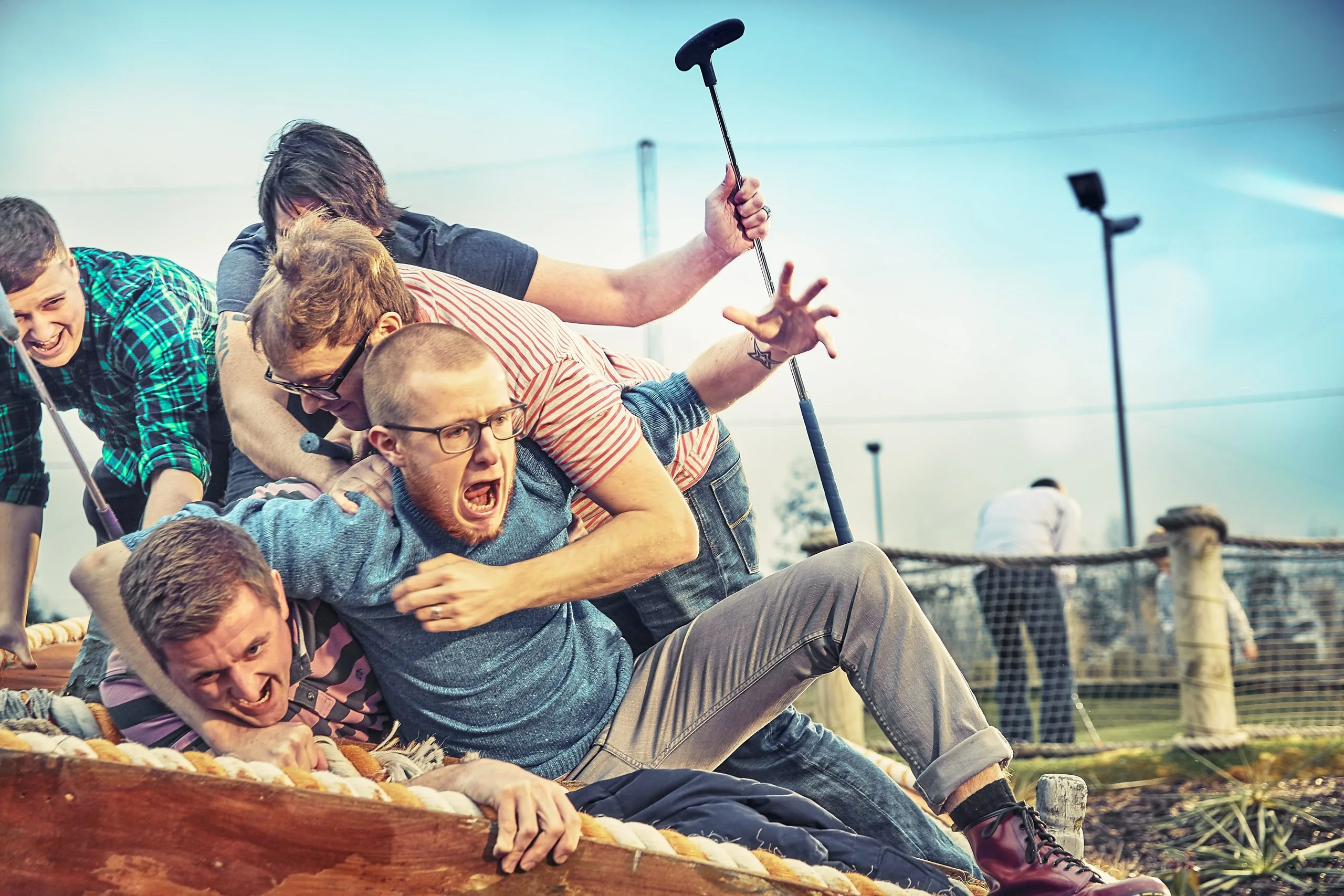 group of adults laughing and joking playing crazy golf in milton keynes