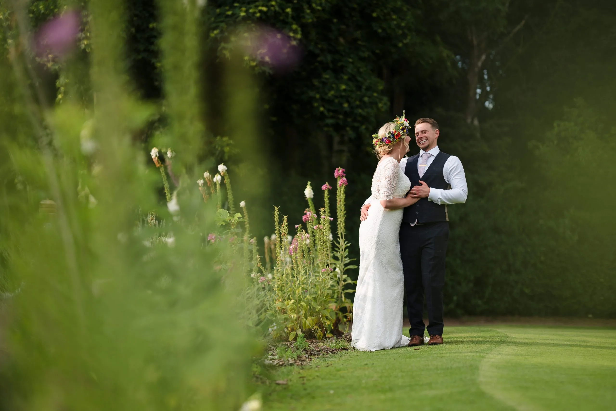 newly married couple walking along golf course grounds
