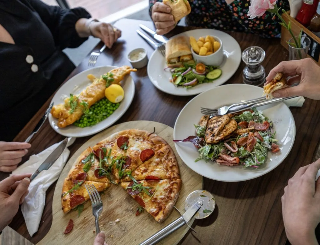 Four plates of delicious food at a table in a restaurant in Milton Keynes