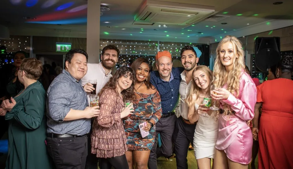 Group of people smiling at a Christmas party in Milton Keynes