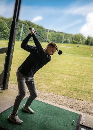 man playing virtual golf in buckinghamshire
