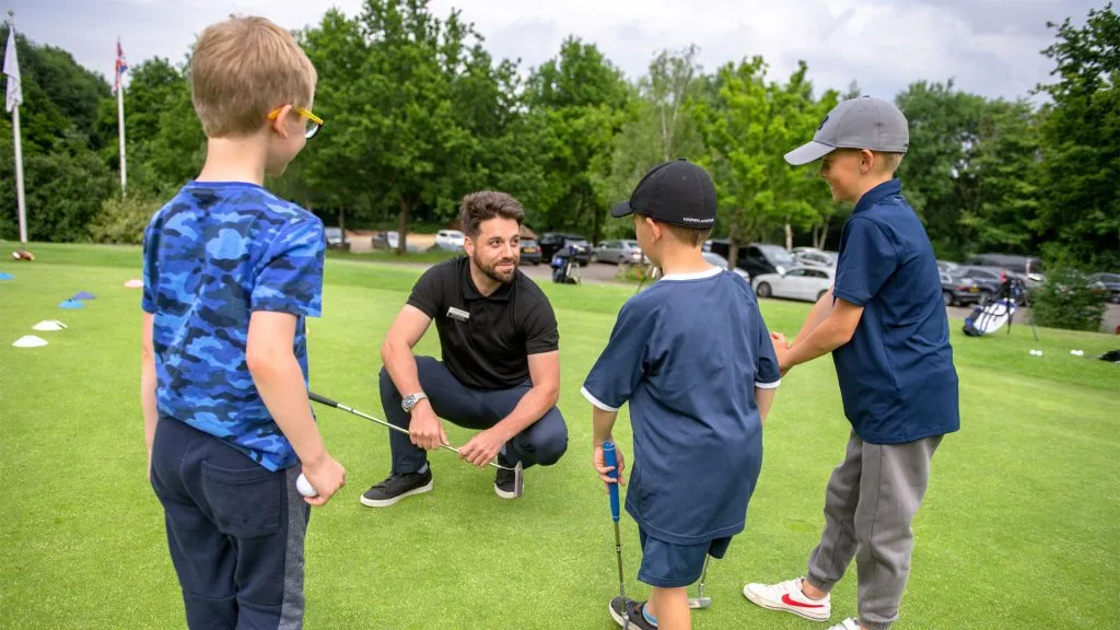 golf coach teaching junior golf lesson in buckinghamshire