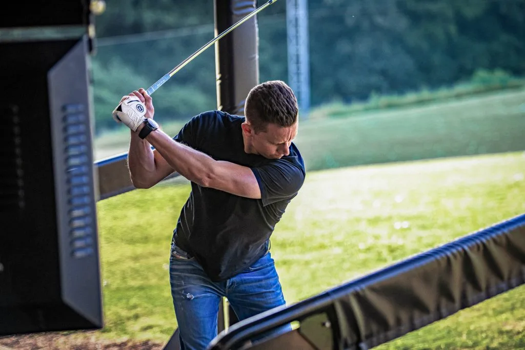 man hitting balls out of driving range near milton keynes