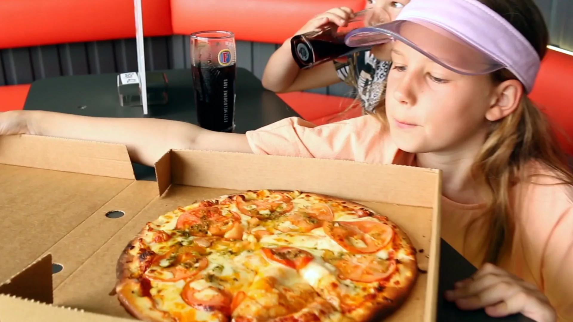 child admiring pizza at the trackman driving range in milton keynes